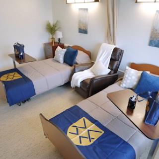 A cozy and well-furnished bedroom featuring two beds, comfortable seating, and tasteful decor.