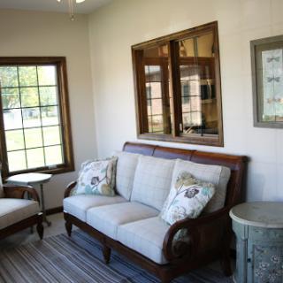 A cozy living room featuring elegant furniture and abundant natural light.