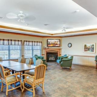 A cozy, well-lit living room with comfortable furniture and a fireplace.