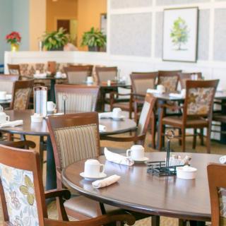 An empty restaurant dining area set up with tables and chairs.