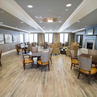 A spacious and modern dining room featuring ample seating, large windows for natural light, and elegant decor.