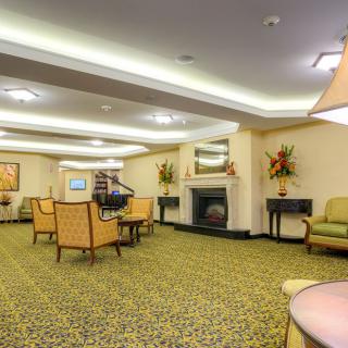 A cozy lobby with comfortable seating and a fireplace.