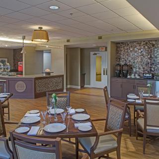 A neatly arranged restaurant dining area with set tables and comfortable seating.