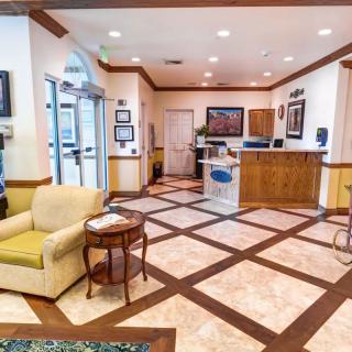 A spacious and well-decorated lobby featuring comfortable seating and a reception desk.