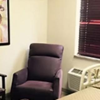 A cozy room featuring a comfortable armchair beside a window.