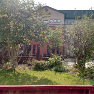 A view of a building surrounded by greenery.