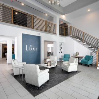 A modern lobby with stylish furniture and a central seating area.