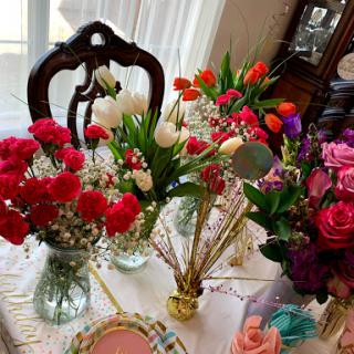 A beautiful display of various colorful flower arrangements adorning a table, perfect for any celebration or home decor.