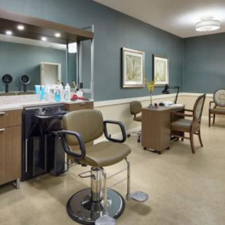 A well-organized beauty salon with styling chairs and grooming stations.