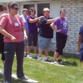 Group of people participating in an outdoor team-building activity.