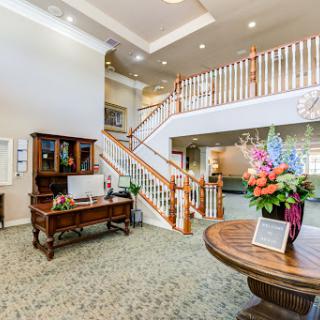 A welcoming reception area featuring elegant decor and a staircase.