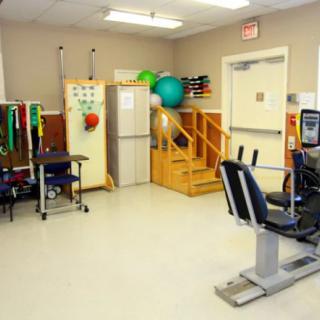A physical therapy room equipped with various exercise tools and rehabilitation equipment.