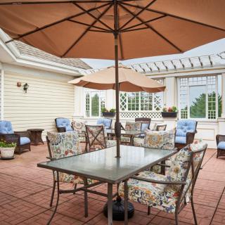 A cozy outdoor patio area with seating and an umbrella, perfect for relaxation.