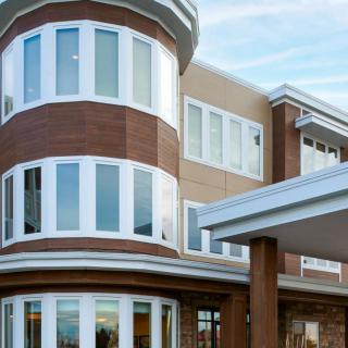 A contemporary building with a unique curved design and large windows.