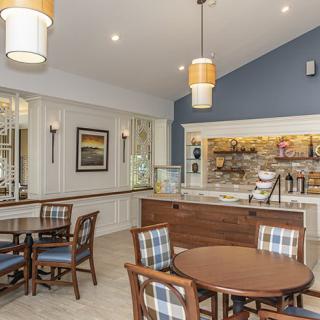 A cozy cafe interior with tables and a counter.