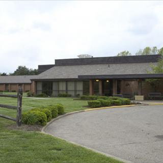 A school building with a driveway and well-maintained landscape.