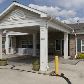 A residential building with a covered entrance and columns.