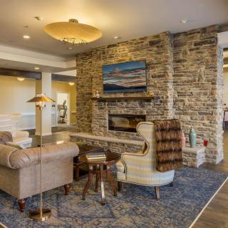 Cozy living room with a stone fireplace and comfortable seating.
