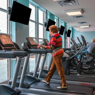 A person using a treadmill in a gym setting.