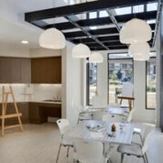 A modern dining area with stylish pendant lights and contemporary furniture.