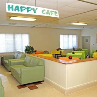 A brightly lit cafe interior with colorful seating and a welcoming atmosphere.