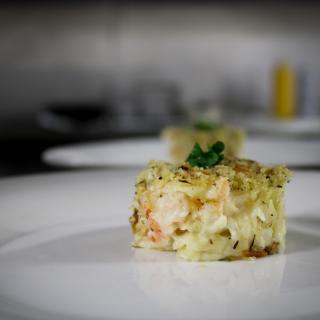 A delicately plated gourmet seafood dish garnished with herbs.
