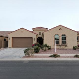 A modern single-story house with a garage and well-maintained landscaping.