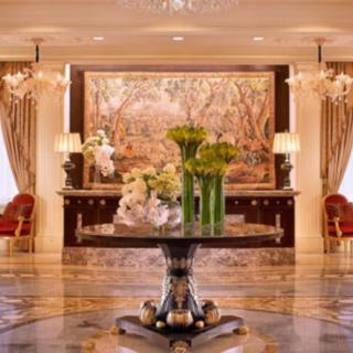 A luxurious hotel lobby with elegant decor and floral arrangements.