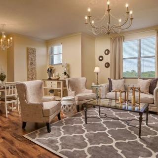 A stylish and cozy living room with elegant furniture and a chandelier.