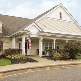 A well-maintained house with an American flag displayed at the entrance.
