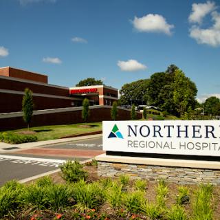 Entrance to Northern Regional Hospital, featuring clear signage and a well-maintained landscape.