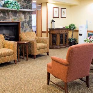 A cozy living room with comfortable chairs and a fireplace.