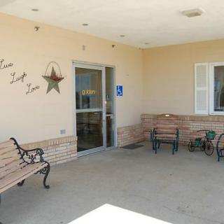 Outdoor entrance area with benches and chairs.