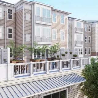 A modern apartment building with spacious balconies and a stylish design.