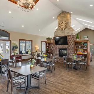 A cozy dining area with a fireplace and elegant decor.