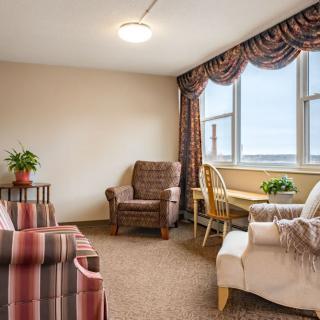 A cozy living room with comfortable seating and a large window overlooking the view.
