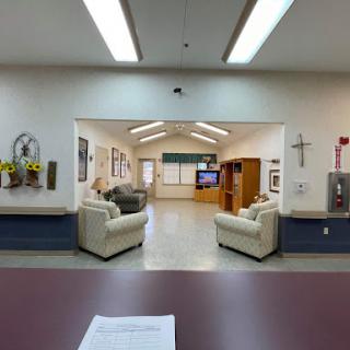 A spacious waiting area with comfortable seating and a television.