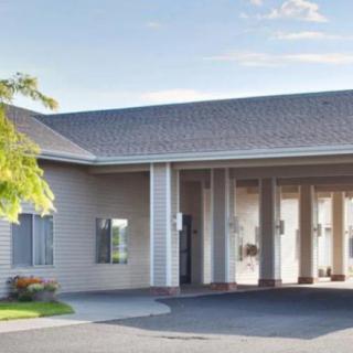 A building exterior with a covered entrance on a sunny day.