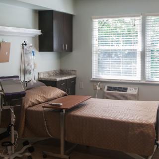 A hospital room with a patient bed and medical equipment.
