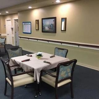 A neatly arranged dining table in a cozy indoor setting with wall decorations.
