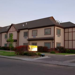A two-story apartment building in a suburban neighborhood.