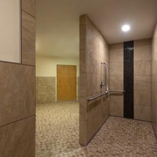 An accessible shower area with tiled walls and a spacious layout.