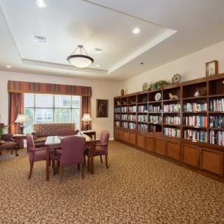 A cozy library room with bookshelves and a reading area.