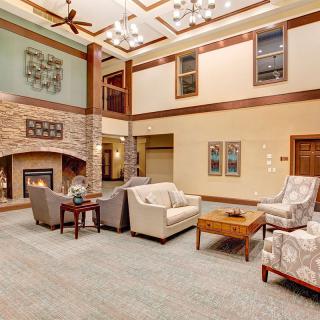A spacious and elegantly designed living room with a cozy fireplace and comfortable seating.