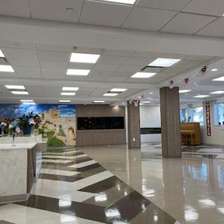 A spacious and modern office lobby featuring elegant flooring and bright lighting.