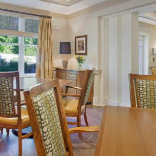 A cozy dining room with wooden furniture and elegant decor.