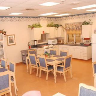 Cozy kitchen and dining area with wooden furniture and decorative plants.