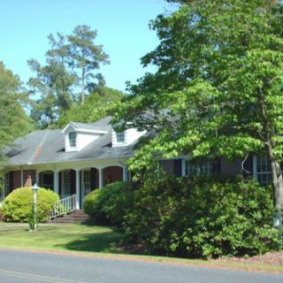 A charming residential home surrounded by lush greenery.
