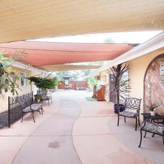A charming courtyard with shaded seating and decorative plants.