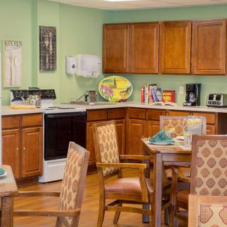 A cozy kitchen and dining area with wooden cabinets and furniture.